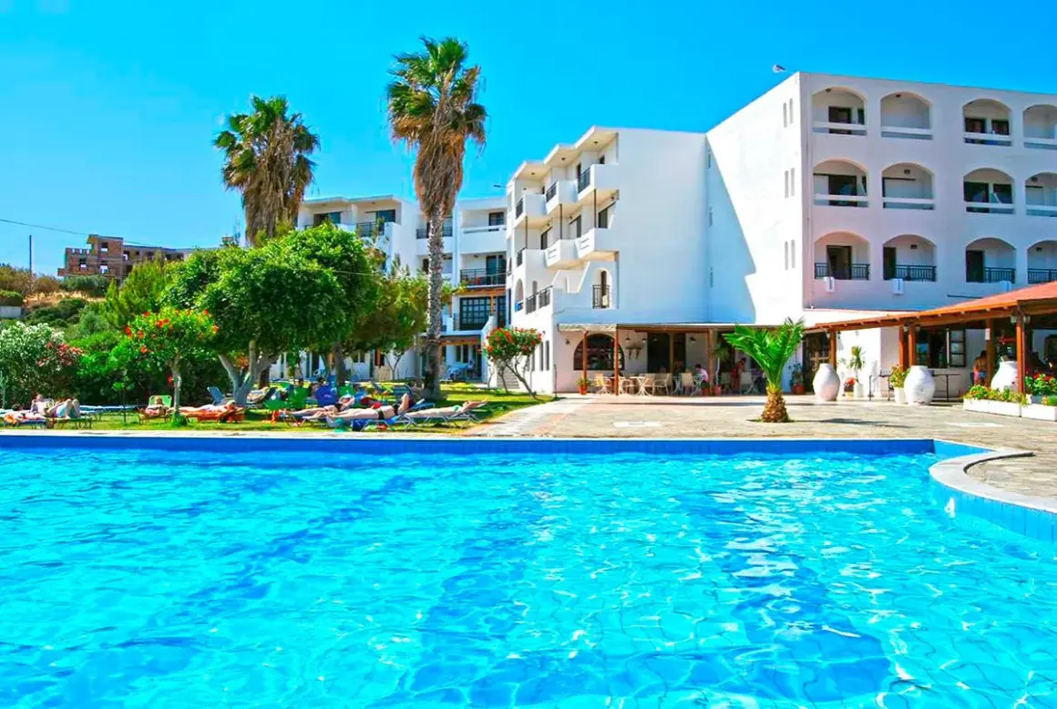 Basen i hotel z palmami. Wiele osób odpoczywa na leżakach. Idealne miejsce na wakacje, jak sugerują ocean heights view hotel opinie.